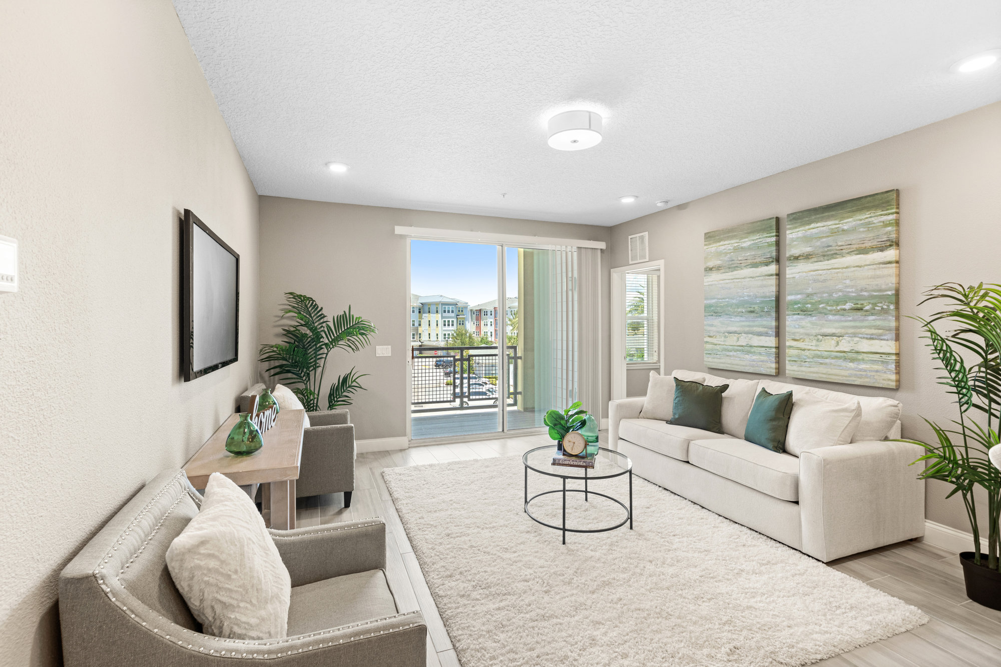 living room with windows to private balcony and hallway